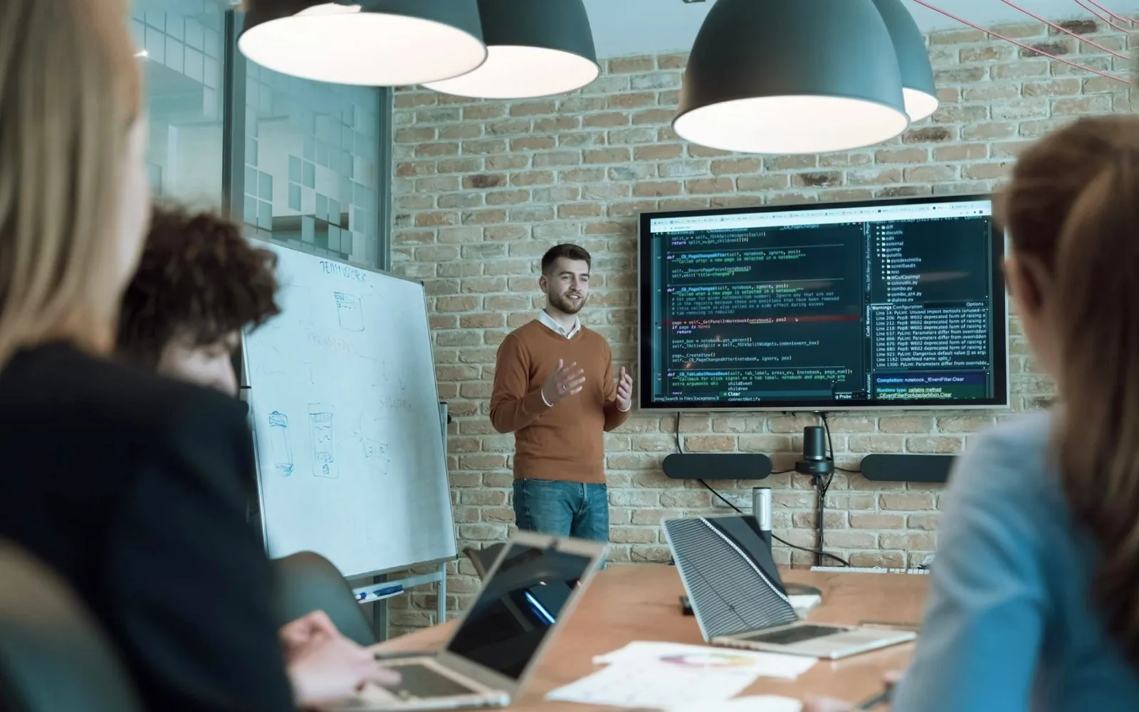 Software development team discussing application architecture, coding standards and custom software solutions